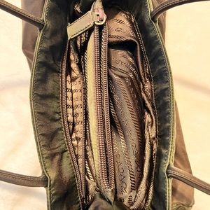 Prada black bag and has green stain around the corners